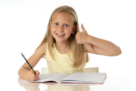 Cute Young Girl Studying at Home on a Desk with a Study Book on a White Background Stock Photo ...