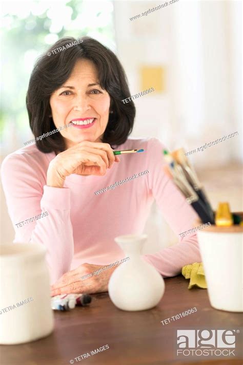 Senior woman painting handmade pottery, Stock Photo, Picture And Royalty Free Image. Pic. TET ...
