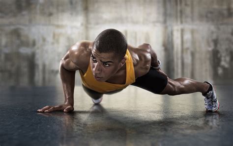 Sport. Young athletic man doing push-ups. Muscular and strong guy ...