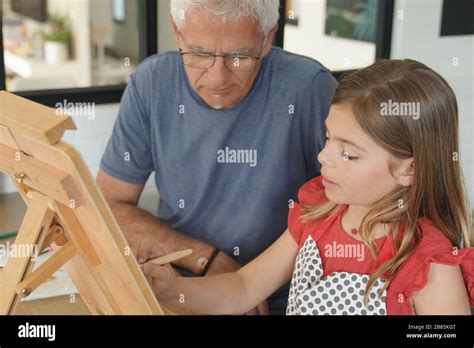 a father with his daughter painting Stock Photo - Alamy