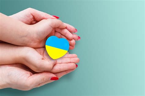 Premium Photo | The national flag of ukraine with the coat of arms in female hands flat lay copy ...