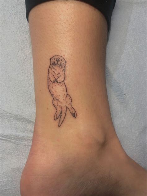 Adorable sea otter tattoo