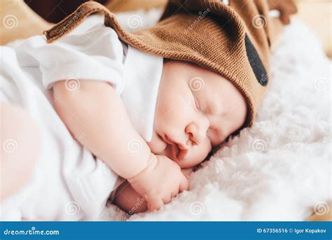 Cute Baby in Deer Hat Sleeps Stock Photo - Image of knitted, deer: 67356516