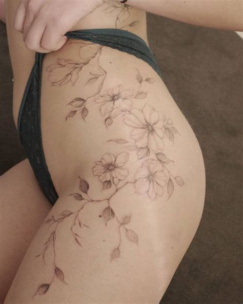 Illustrative style dog roses tattoo located on the hip.