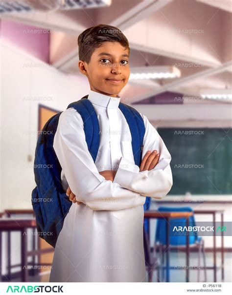 Saudi Arabian Gulf student wearing school uniform, school backpack, hands crossed, preparing for ...