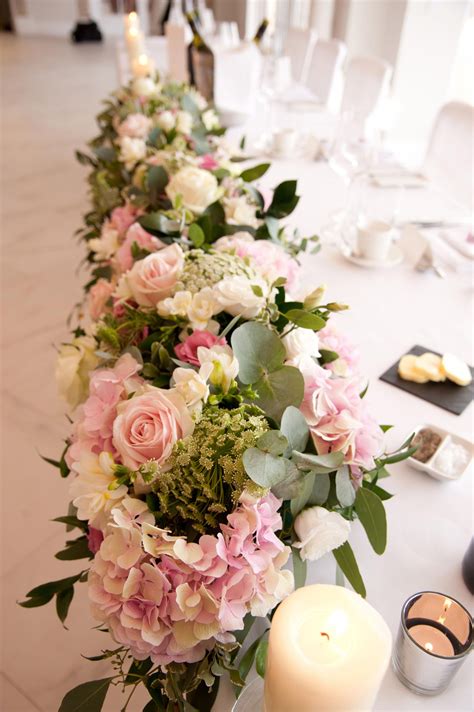 Top Table design by Eden Blooms at Froyle Park, image by Lawrence Photography. Flowers include ...