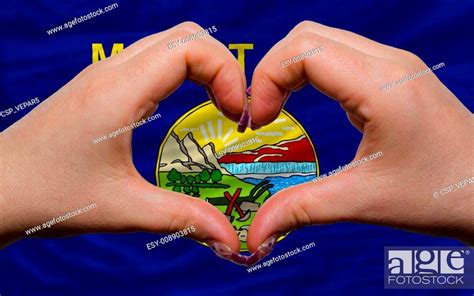 Gesture made by hands showing symbol of heart and love over us state flag of montana, Stock ...