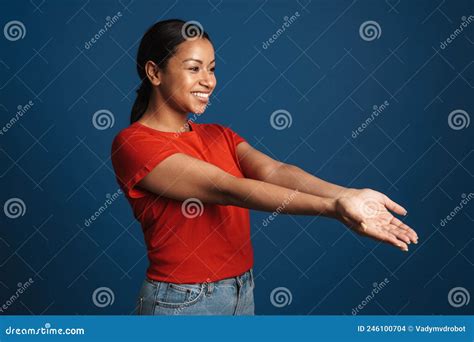 Young Black Woman Smiling and Reaching Out Her Hands Aside Stock Photo ...