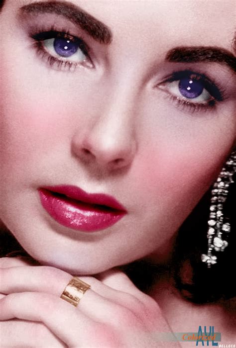 a close up of a woman with blue eyes and rings on her fingernails