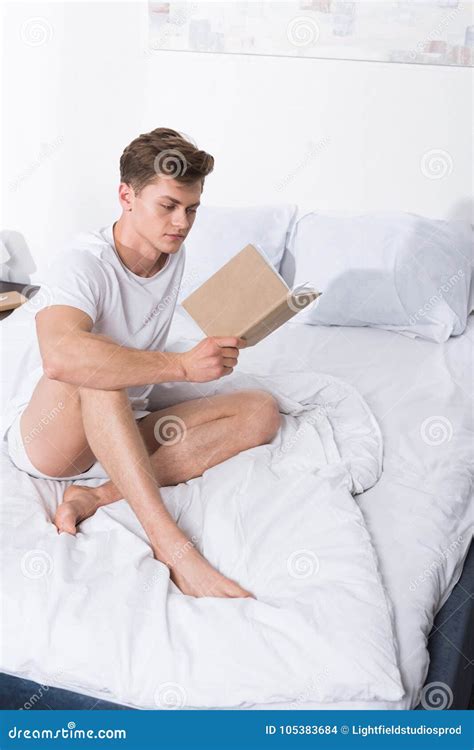 Man reading book in bed stock photo. Image of underwear - 105383684