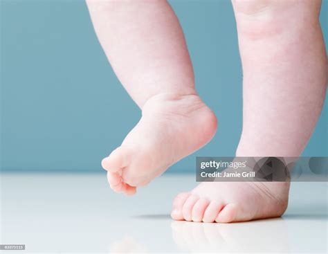 Baby Taking First Steps High-Res Stock Photo - Getty Images