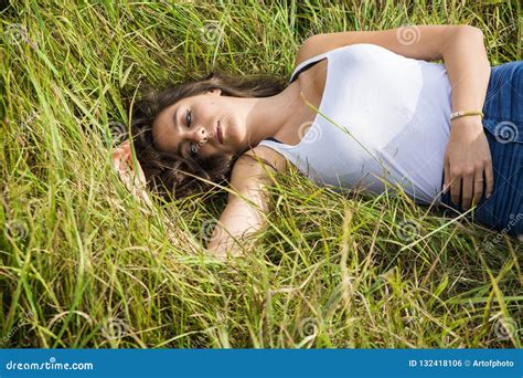 Smiling Brunette Laying on Grass in Sunlight Stock Photo - Image of sunlight, model: 132418106