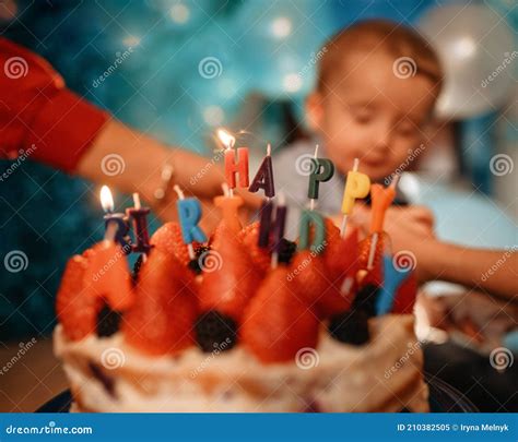 Boy Eating Birthday Cake with Candles Against Blue Balloons Stock Image ...