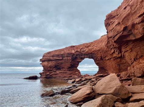 Red Sandstone Sea Cliffs Under an Overcast Sky at Cavendish Beach ...