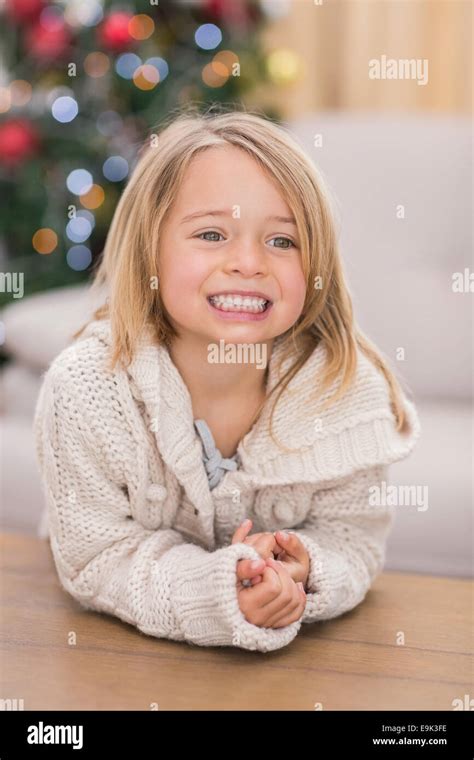 Festive little girl smiling at coffee table Stock Photo - Alamy
