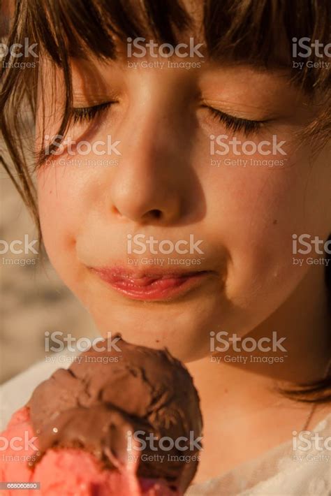 Girl Face Eating An Ice Cream At Sunset Beach Stock Photo - Download Image Now - Ice Cream ...