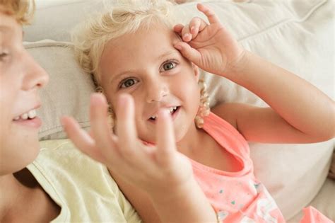 Premium Photo | Smiling little girl playing on sofa at home