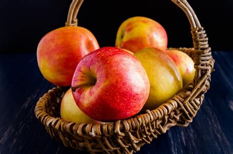 Premium Photo | Bunch of organic red apples in wicker basket.