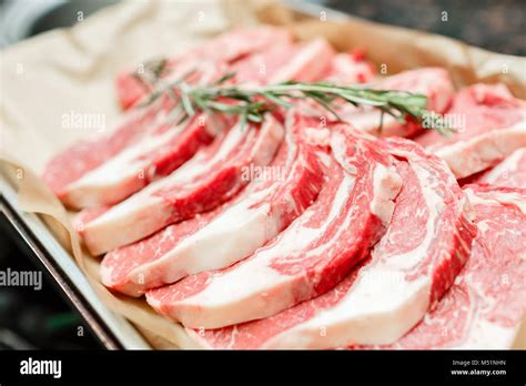 Selection of different cuts of fresh raw red meat in a supermarket ...