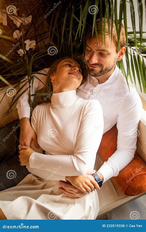 Beautiful Young Couple Lies Embracing in Modern House Stock Photo - Image of cozy, couple: 233519338