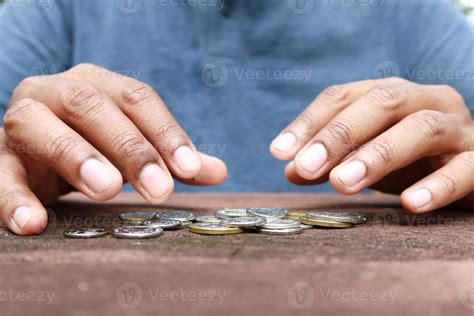 Close up of man hand counting coins 16243248 Stock Photo at Vecteezy