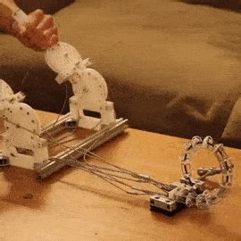 two robotic arms are attached to a coffee table