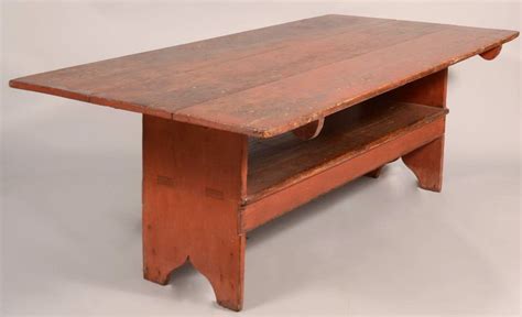 an old wooden coffee table with wheels on the top and bottom shelf ...