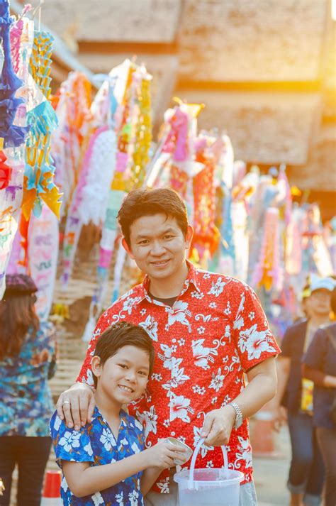 Thai family participate old traditional activity in a temple during Songkran festival in Chiang ...