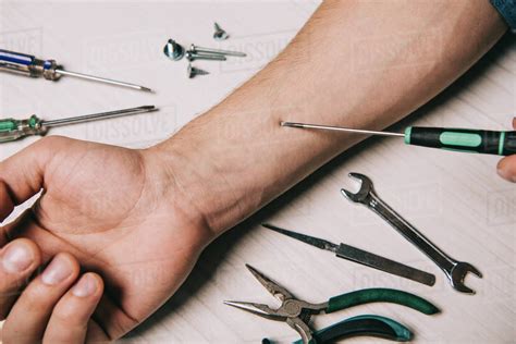 Cropped view of man fixing hand with tools - Stock Photo - Dissolve