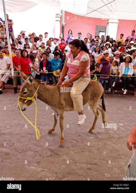 Mexican woman riding a donkey Stock Photo - Alamy