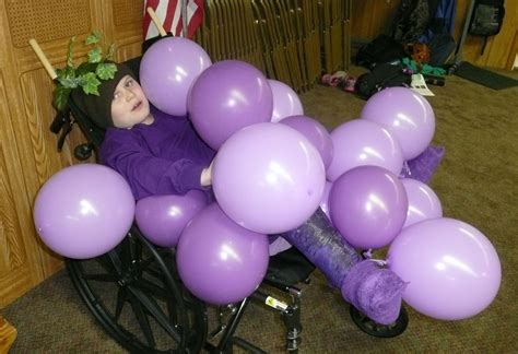 Stuck in a wheelchair and a purple full body cast, Logan was a bunch of grapes for Halloween ...