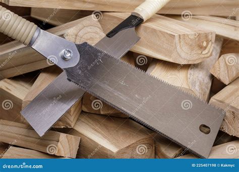 Hand saw and wood planks stock photo. Image of hardware - 225407198