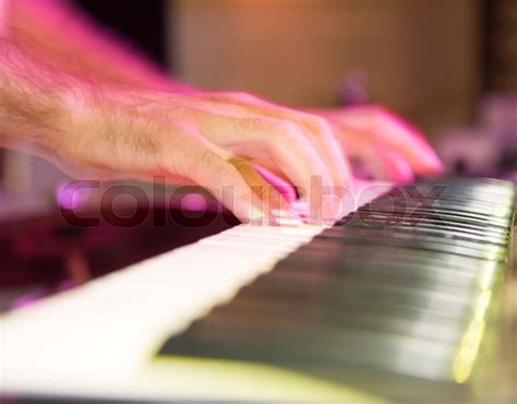 Musician plays keyboards in a rock band | Stock image | Colourbox