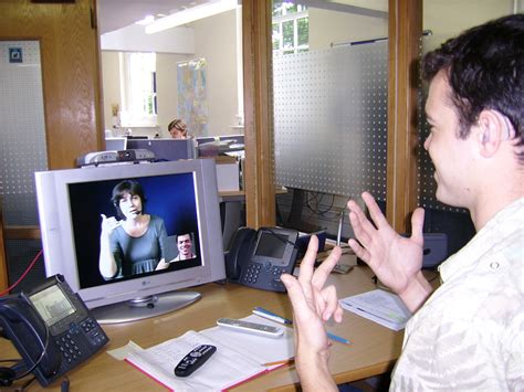 File:Deaf or HoH person at his workplace using a Video Relay Service to communicate with a ...