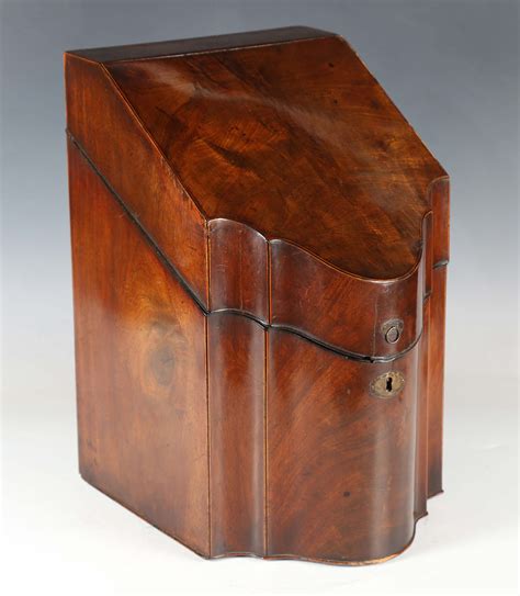 A George III mahogany knife box, the hinged lid enclosing a later fitted letter rack, width 23cm.