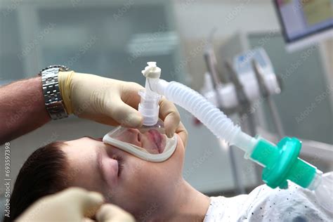 A child with an oxygen mask on his face. Preparing the child for anesthesia. Dental surgery ...