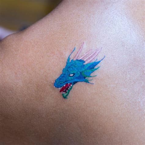 Blue dragon head tattoo on the left shoulder blade | Shoulder tattoo, Blue tattoo, Dragon head ...