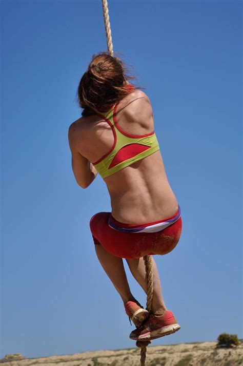 Strong Woman Rope Climbing on A Sunny Day. Woman Doing Rope Exercise Outdoors
