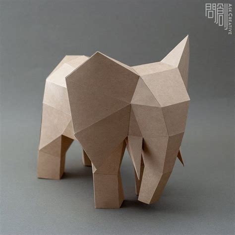 an origami elephant is standing on the ground