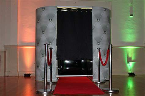 a red carpet is on the floor in front of a white stage with black curtains