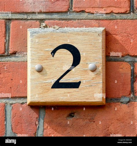 House Number 2 sign on wooden block attached to wall Stock Photo - Alamy