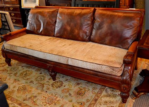 Wood frame sofa with Cane back and sides and leather cushions. Can be ...