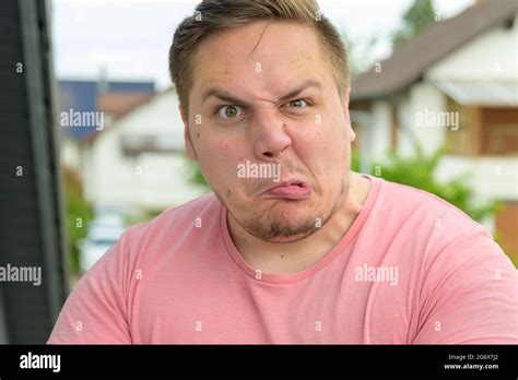 Young man raised eyebrow hi-res stock photography and images - Alamy