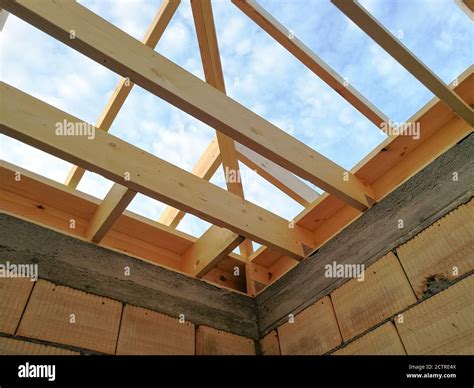 Wood girder beams for new roof construction at construction site Stock ...