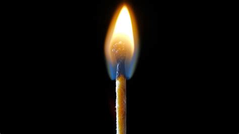 Close-up On Candle Lit Match On Black Background. Close-up On Candle Flame On Black Background ...