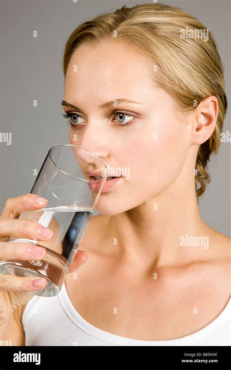 Young woman drinking water Stock Photo - Alamy