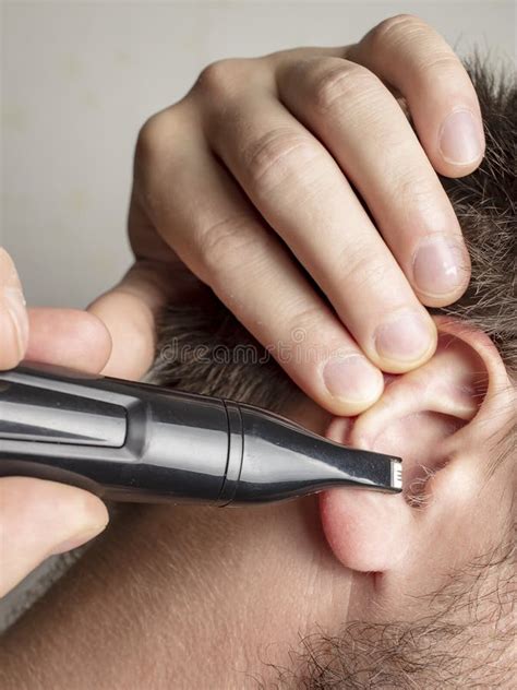 Young Man Trimming Ear Hair Stock Image - Image of routine, male: 136690425