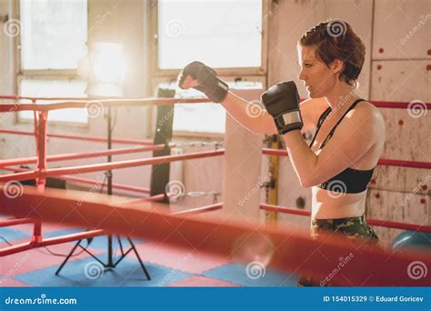 Young Woman Prepares for Matches MMA in the Cage. Training in a Sport ...