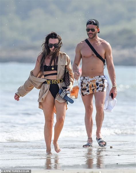 Love Island's Rosie Williams strolls on the beach in Ibiza with banker lover Wayne Davies ...