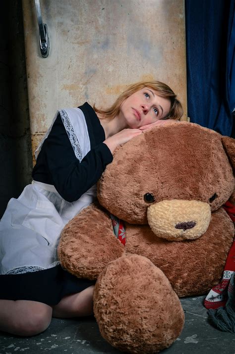 Sad woman in school uniform hugging toy bear · Free Stock Photo